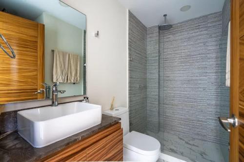 a bathroom with a sink and a toilet and a shower at Nuevo Vallarta Peaceful Loft in Nuevo Vallarta