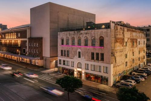 a building with a pink light on the side of it at Schaeffer Hotel in New Orleans