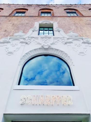 a building with a window with the words sutterier on it at Schaeffer Hotel in New Orleans