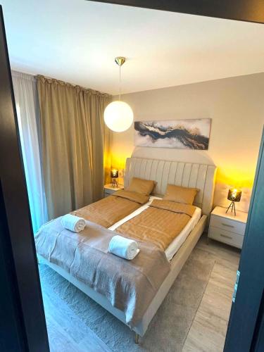 a bedroom with a large bed with two pillows at Luxiva Home in Nyíregyháza