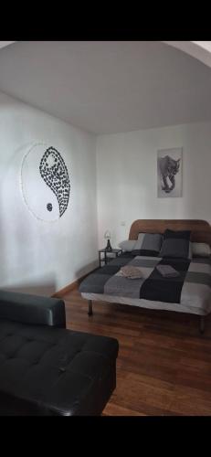 a bedroom with two beds and a couch in it at The Loft'y #3 in Famara
