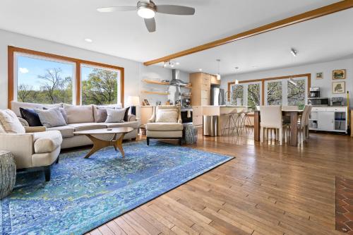 a living room with a couch and a table at Spacious House with Modern Comforts and Nature in Cushing