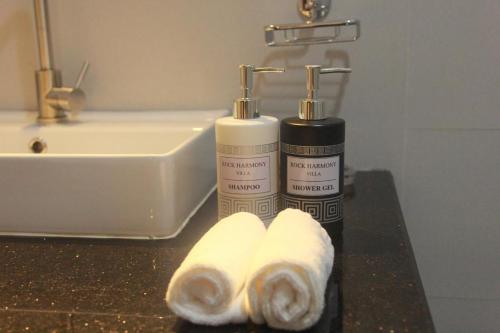 two bottles ofodorizers on a counter in a bathroom at Rock Harmony Villa in Dodanduwa