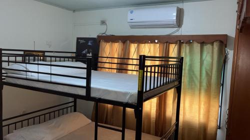 two bunk beds in a room with a fan at The Doctor's Quarters DQ in San Fernando