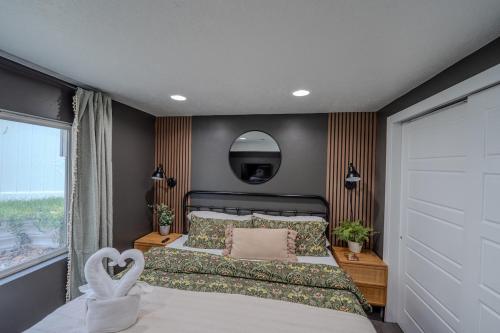a bedroom with a large bed and a mirror at Modern Basement Apartment King Bed and Full Kitchen in Bluffdale