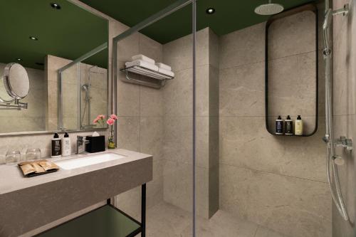 a bathroom with a sink and a shower at Novotel Bhubaneswar Janpath in Bhubaneshwar