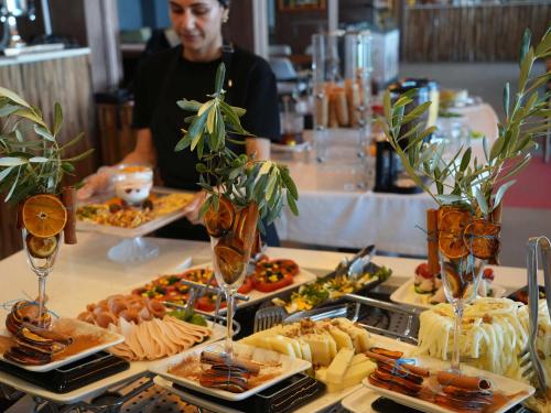 a buffet with plates of food on a table at ERTAN OTEL in Çeşme