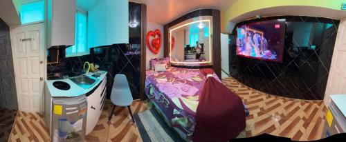 a bathroom with a sink and a tv in a room at Gold House Premium in Quito