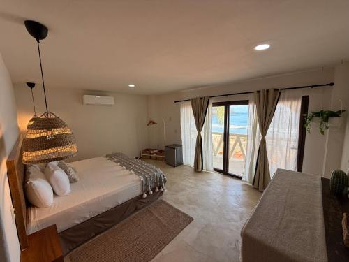 a bedroom with a bed and a large window at Seres Sayulita Beach Hotel in Sayulita