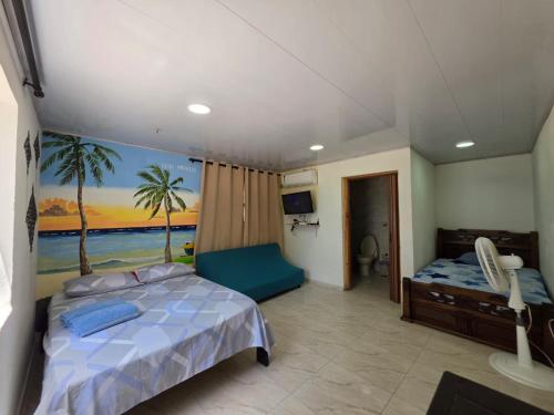 a bedroom with a bed and a painting on the wall at Bella Marcela in Buenavista