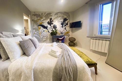 a bedroom with a large white bed with a window at Signature Design & Panoramic Views in Montecatini Terme