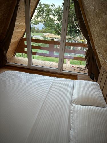 a bed in a room with a window at Villa Venus in Ferizaj