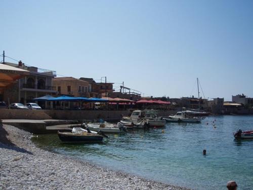 a group of boats are docked in a harbor at Akti Kamares in Kamáres