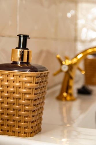 a bottle of soap sitting on a bathroom counter at Valero Hôtel in Cotonou