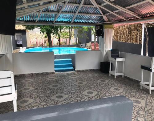 a patio with a swimming pool with a table and chairs at Villa Naranja AYD in Paredón