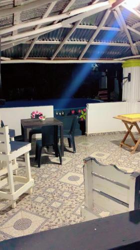 a patio with a table and chairs on a floor at Villa Naranja AYD in Paredón