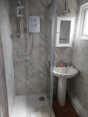 a bathroom with a shower and a sink at Grand Chalet 64 Disabled Friendly in Skegness