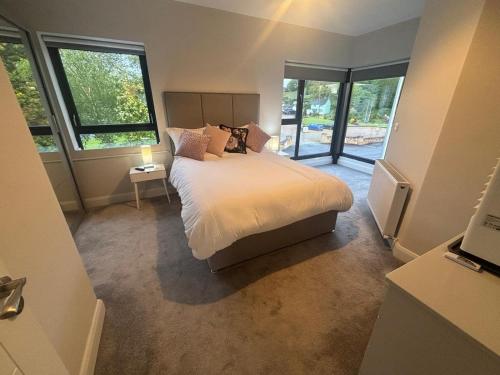 a bedroom with a bed in a room with windows at No2 WestPoint Donegal Town in Donegal