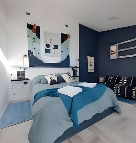 a blue bedroom with a bed with a blue wall at 2 Family Lofts + central heating + comfort in Coihaique