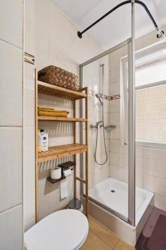 a bathroom with a shower and a toilet and a sink at Charming city in Lausanne
