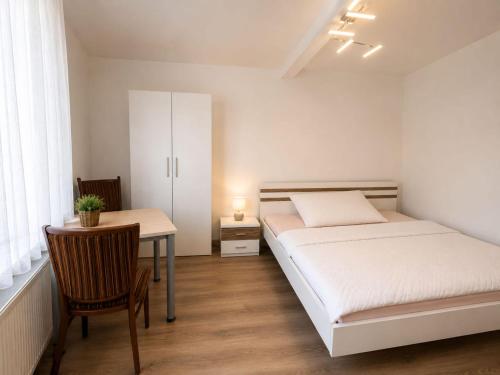 a bedroom with a bed and a desk and a table at Zum Rheinberg Komfort Studio in Braubach