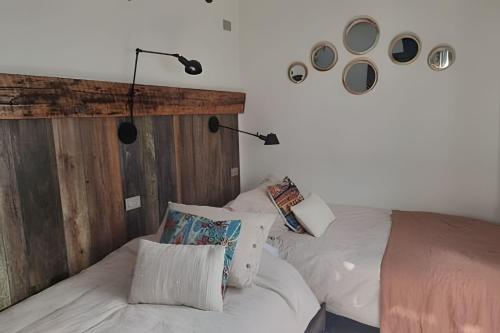 a bedroom with a white bed with two pillows at 6 Universal Access Comfort WiFi central heating in Coihaique