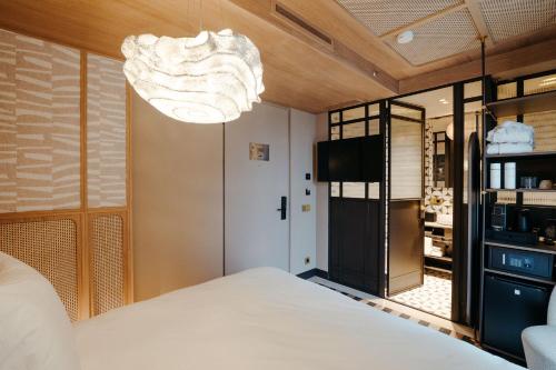a bedroom with a bed and a chandelier at The Diamond Amsterdam in Amsterdam