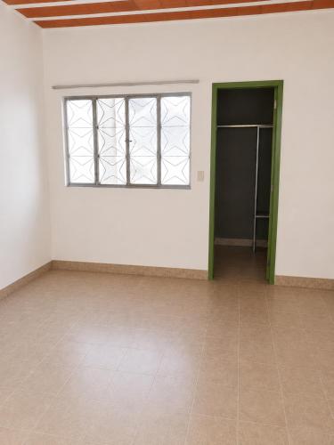 an empty room with a window and a tiled floor at Villa Santa Terezinha in Mesquita
