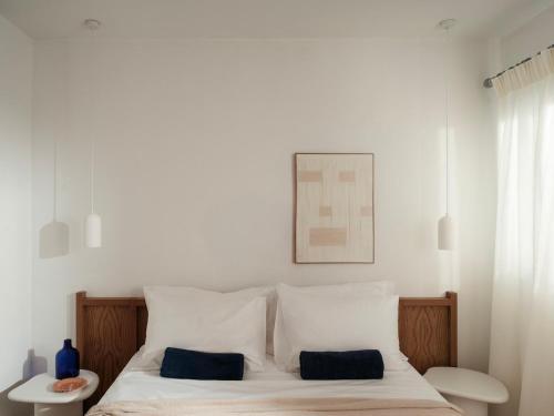 a bedroom with a bed with two pillows on it at Villa Sol Mare Naousa, Paros in Naousa