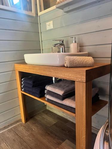 a bathroom with a sink and towels on a table at Houseboat Przystań Spokoju in Ślesin