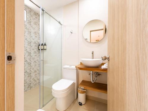 a bathroom with a toilet and a sink and a shower at Hotel Azure Cartagena in Cartagena de Indias