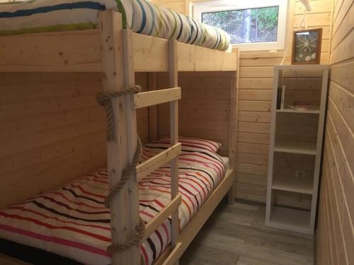 a bedroom with a bunk bed in a cabin at Houseboat Przystań Spokoju in Ślesin