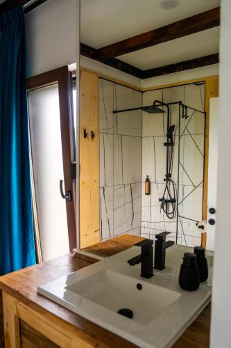 a bathroom with a sink and a shower at K-Home in Stănija