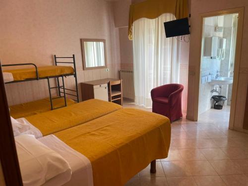 a hotel room with two beds and a bathroom at Hotel Sud America in Fiuggi