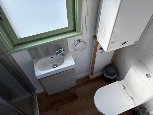 a small bathroom with a sink and a toilet at Sea Farm Stays in Broadstairs