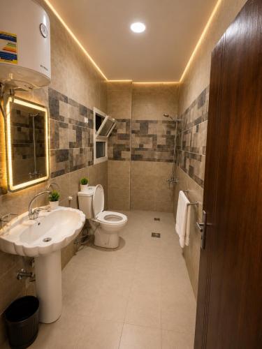 a bathroom with a toilet and a sink at Royal Moses Pyramids View Hotel in Cairo