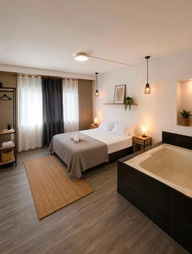 a bedroom with a bed and a bath tub at Ortega La 33 Hotel y Spa in Medellín