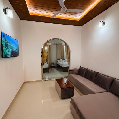 a living room with a couch and a table at Yalora Villa Kataragama in Kataragama