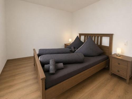 a bedroom with a bed with blue pillows on it at Zum Rheinberg Balcony Suite in Braubach