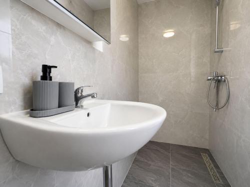 a bathroom with a white sink and a mirror at Zum Rheinberg Balcony Suite in Braubach