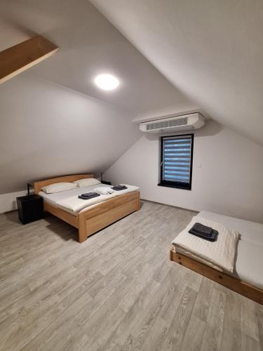 a large room with two beds and a window at Apartmány Aktiv Lipno in Lipno nad Vltavou
