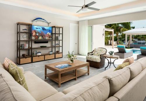 a living room with a couch and a coffee table at Moringa Villa in Long Bay Hills