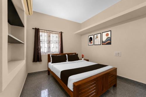 a bedroom with a large bed and a window at Collection O Anbu Nagar Coimbatore in Coimbatore
