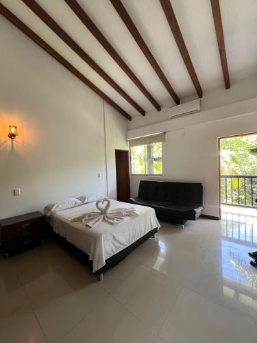 a bedroom with a bed and a couch at Selva del Rio San Jeronimo in San Jerónimo