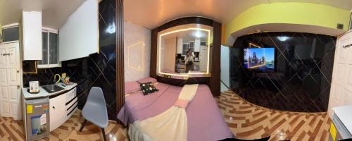 a bathroom with a bed and a sink and a mirror at Gold House Premium in Quito