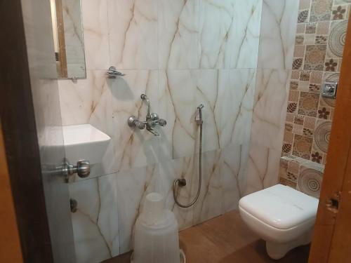 a bathroom with a toilet and a sink at Hotel Bkc Palace Kurla in Mumbai