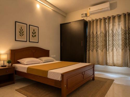 a bedroom with a large bed and a window at sea stay inn in Mahabalipuram