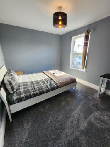 a bedroom with a bed and a window at The Iris in Grays Thurrock