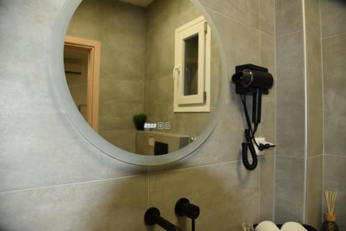 a bathroom with a mirror and a sink at Luxury Green Apartment in Serres