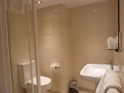 a bathroom with a toilet and a sink at Edgar Townhouse in Bath